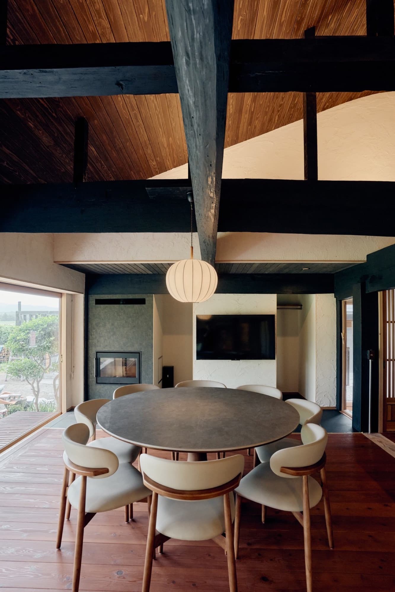 The dining hall under blackened beams and a paper lantern