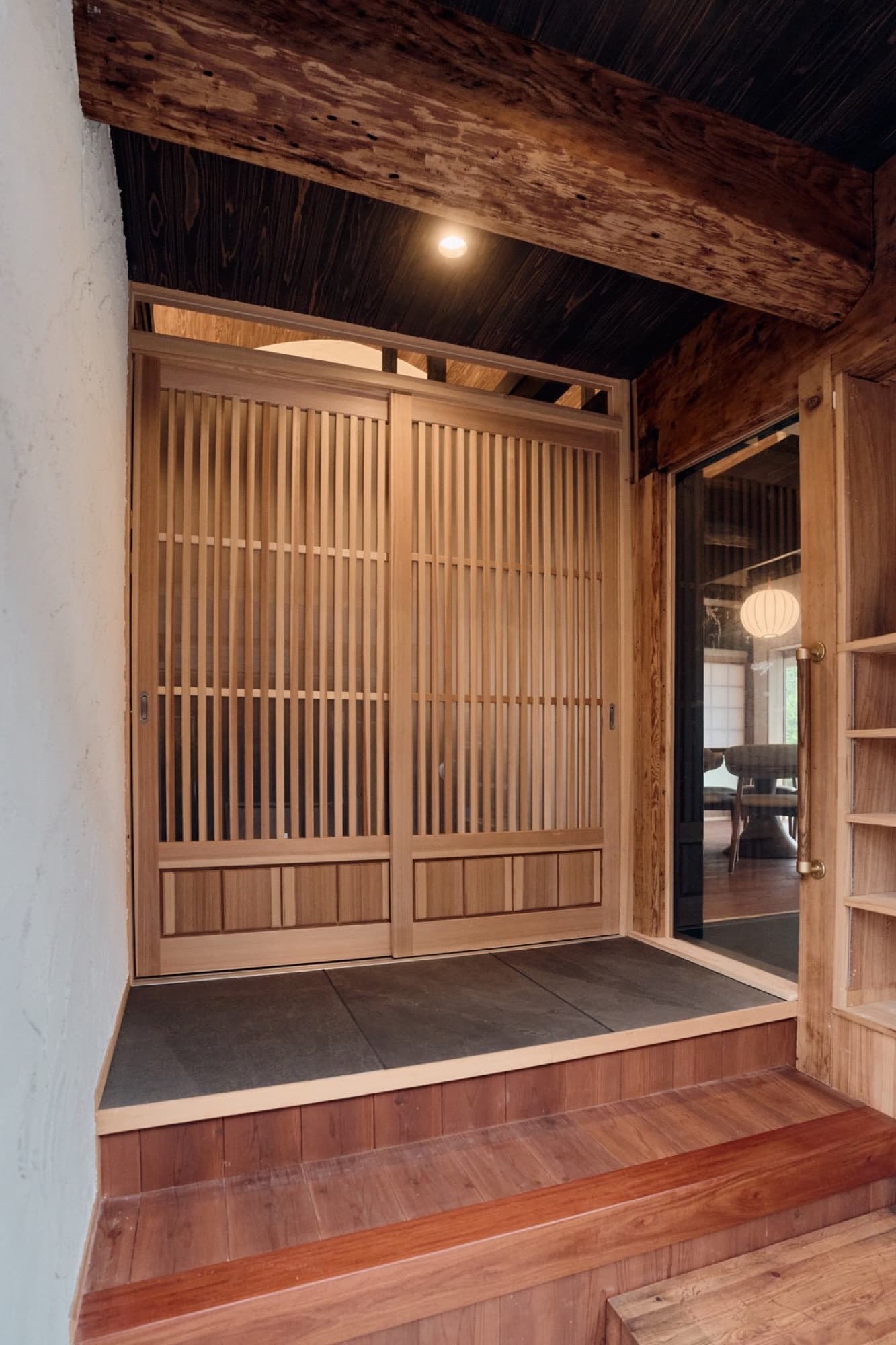 Hand-crafted cedar lattice doors at the entrance